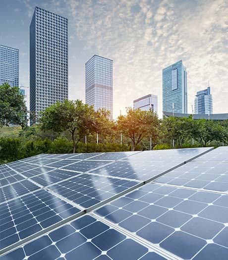 Solarzellen in einem Park vor Hochhäusern